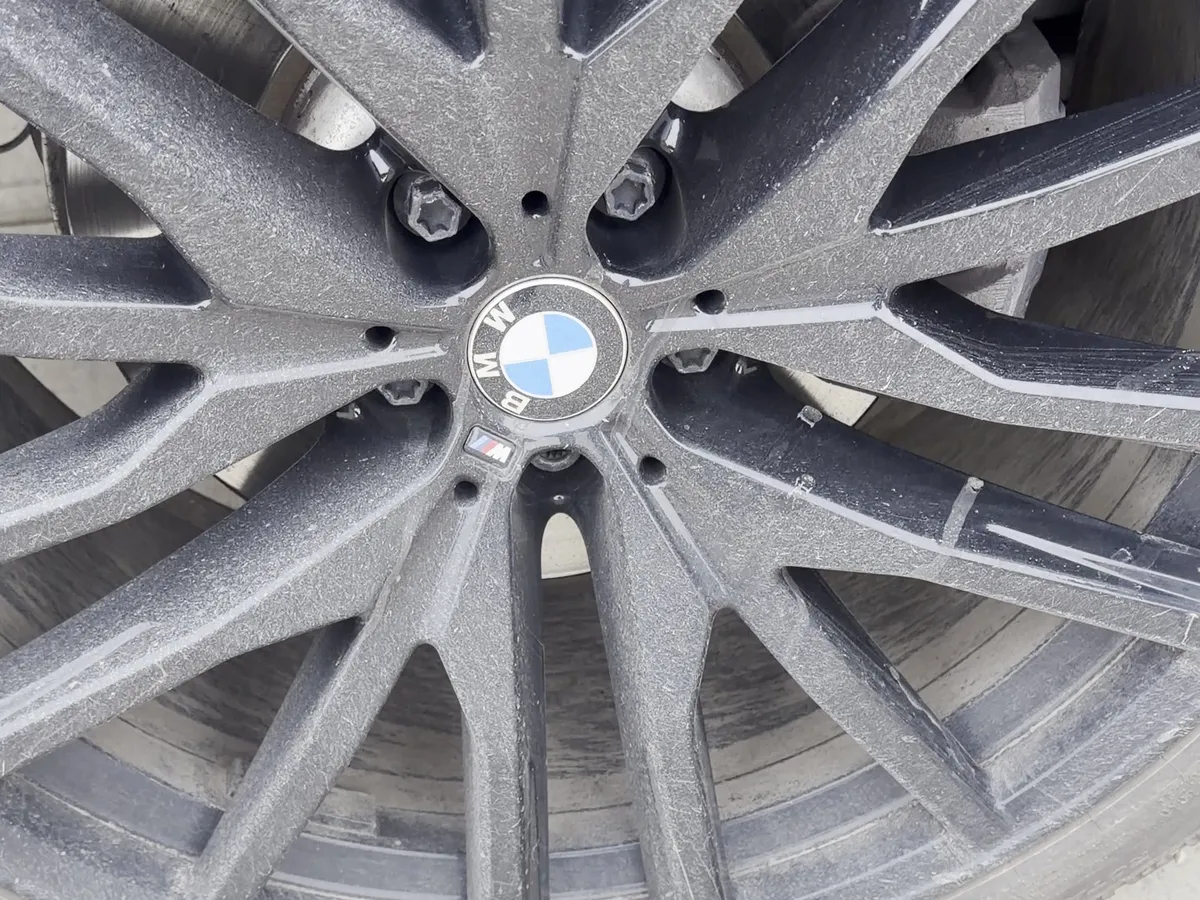 BMW X6 alloy wheel caked in road salt and brake dust before detailing
